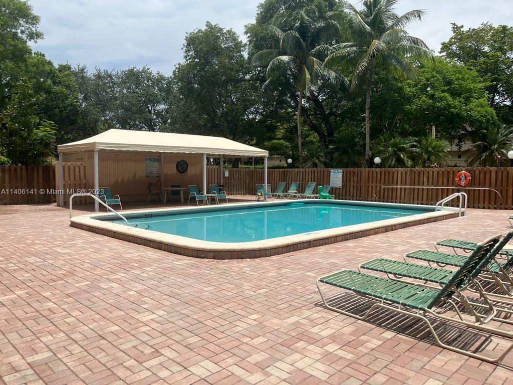 6800 Cypress Road, Unit 211 Plantation, FL 33317 - Photo 18 of 19 a view of a swimming pool with a patio