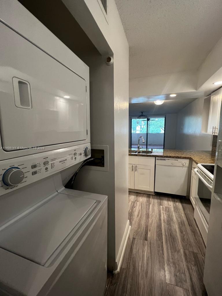 6800 Cypress Road, Unit 211 Plantation, FL 33317 - Photo 2 of 19 a view of a kitchen with a sink and wooden floor