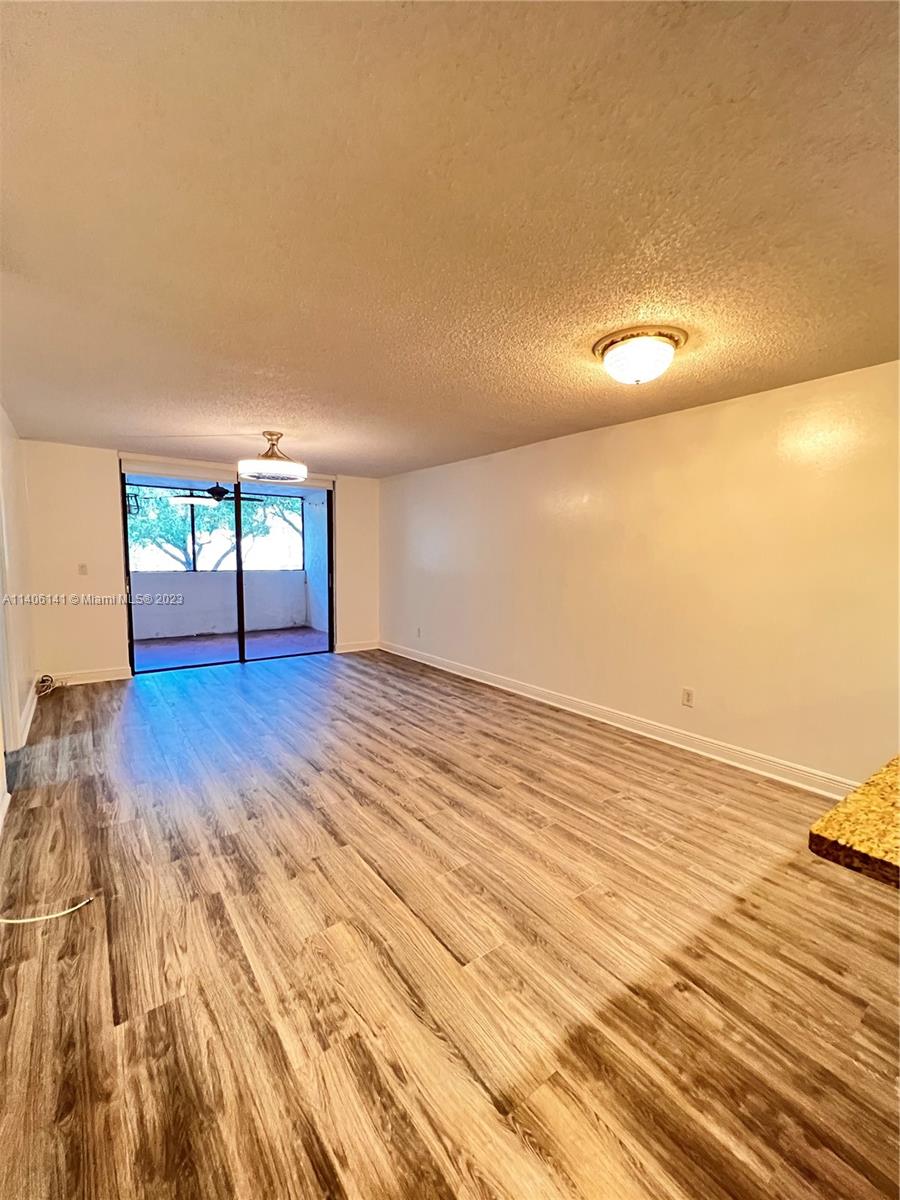 6800 Cypress Road, Unit 211 Plantation, FL 33317 - Photo 3 of 19 a view of empty room with wooden floor