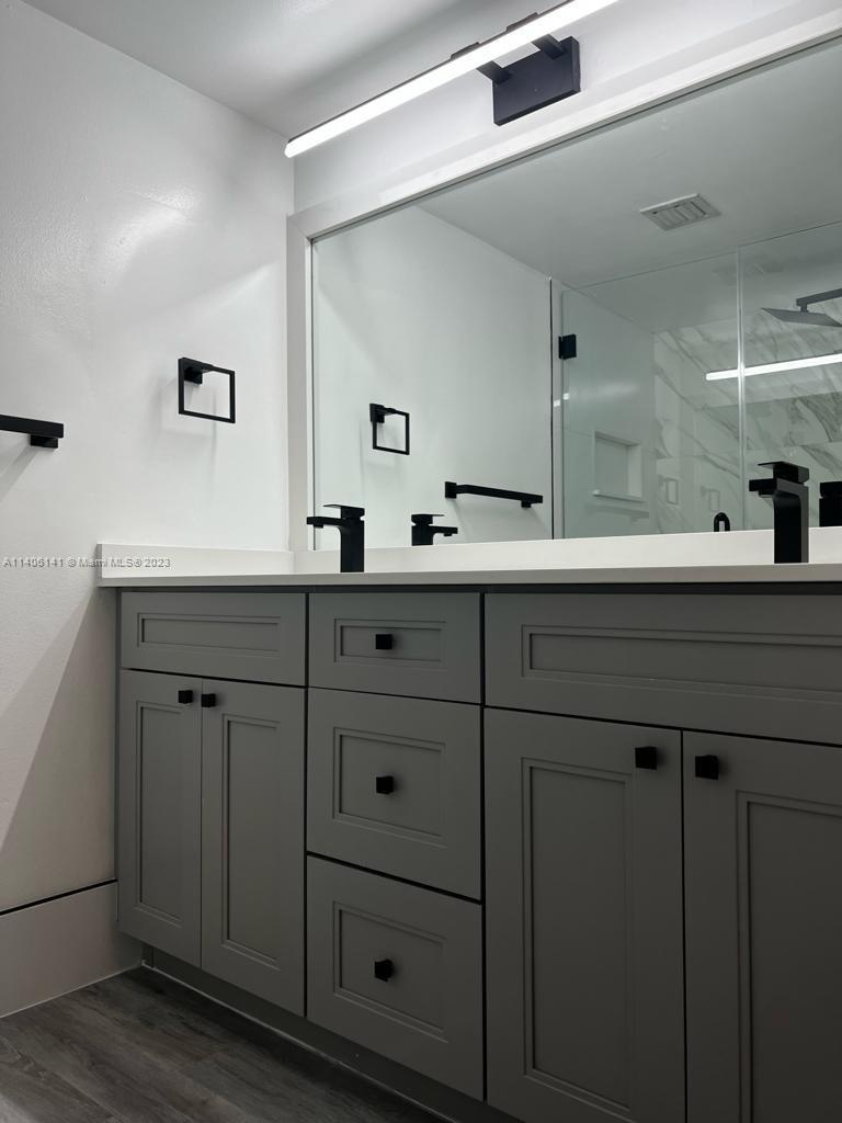 6800 Cypress Road, Unit 211 Plantation, FL 33317 - Photo 5 of 19 a bathroom with a sink and a mirror
