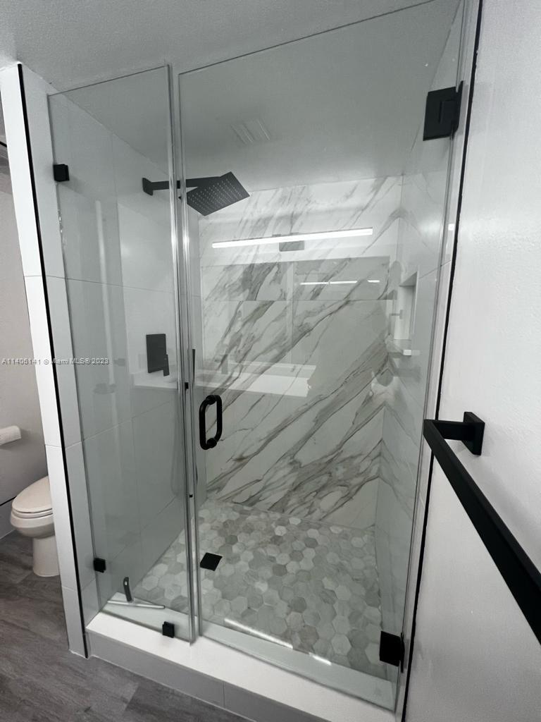 6800 Cypress Road, Unit 211 Plantation, FL 33317 - Photo 6 of 19 a bathroom with a glass door shower