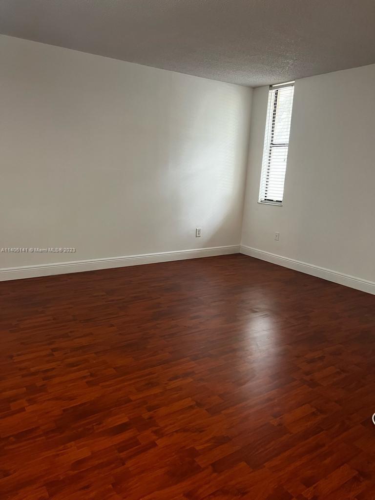6800 Cypress Road, Unit 211 Plantation, FL 33317 - Photo 8 of 19 an empty room with wooden floor and windows