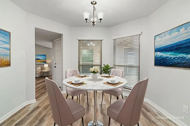 a view of a dining room with furniture window and wooden floor
