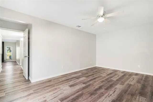 a view of a room with wooden floor