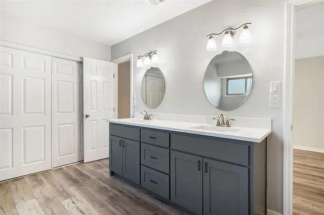 a bathroom with a double vanity sink and a mirror