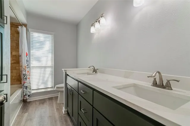 a bathroom with a sink a vanity and a large mirror