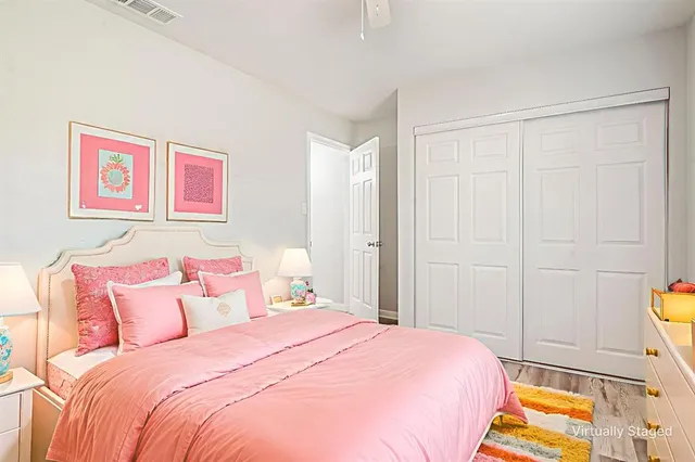 a bedroom with a bed and a painting on the wall