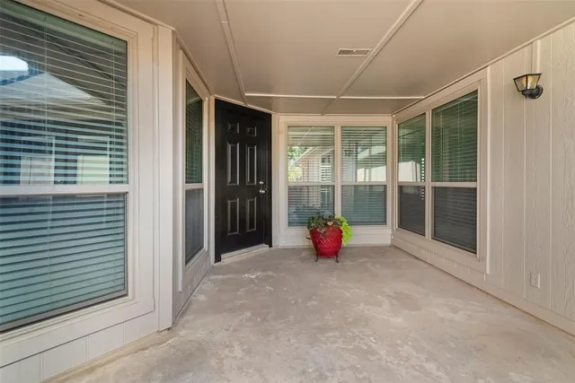 a view of an empty room with a windows