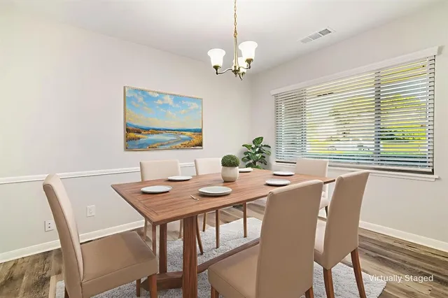 a view of a dining room with furniture window and wooden floor