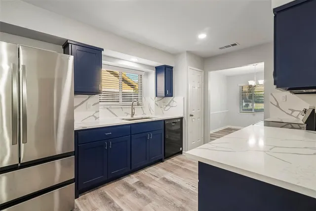 a large kitchen with kitchen island a sink stainless steel appliances and cabinets