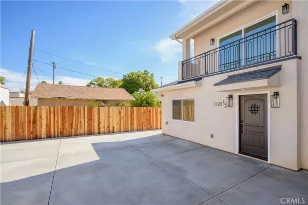 a view of a house with a wooden fence