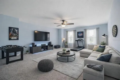 an empty room with fan and windows