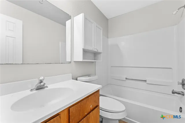 a bathroom with a sink a toilet and vanity