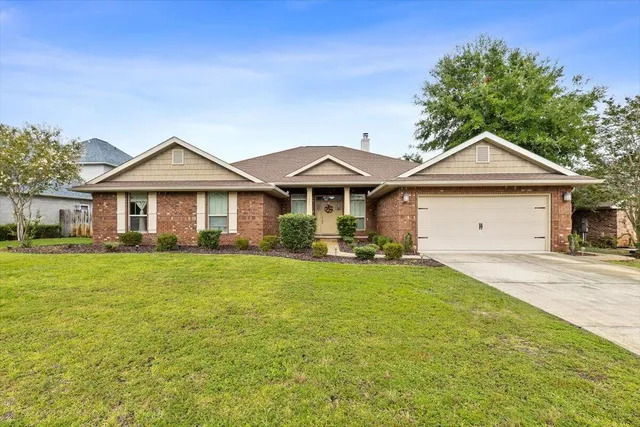 a front view of a house with a garden and porch