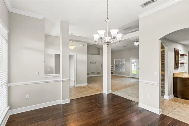 a view of an empty room with a fireplace and a window