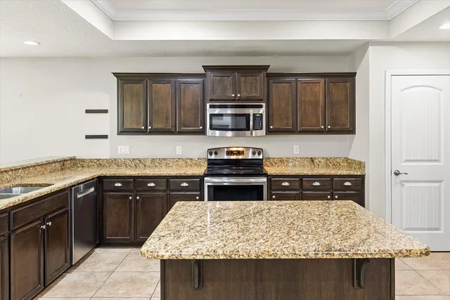 a view of an empty room with a window and a flat screen tv
