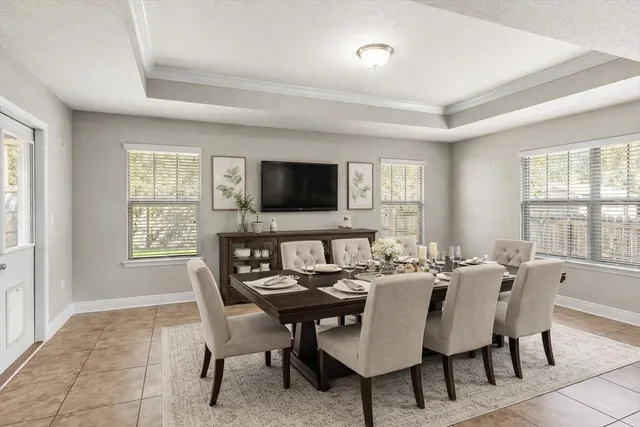 a bedroom with a bed a window and a chandelier