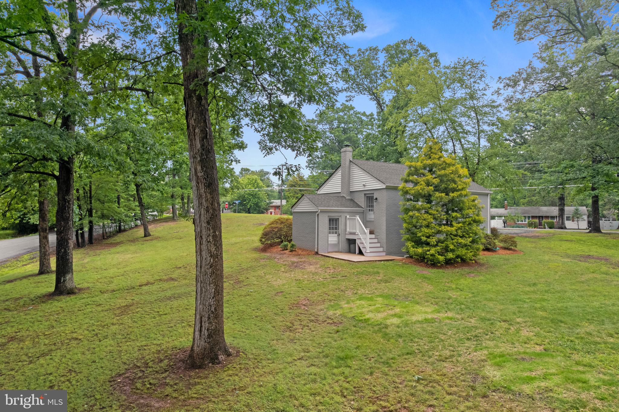 12131 Waples Mill Road Oakton, VA 22124 - Photo 28 of 40 a view of a big house with a tree and a yard