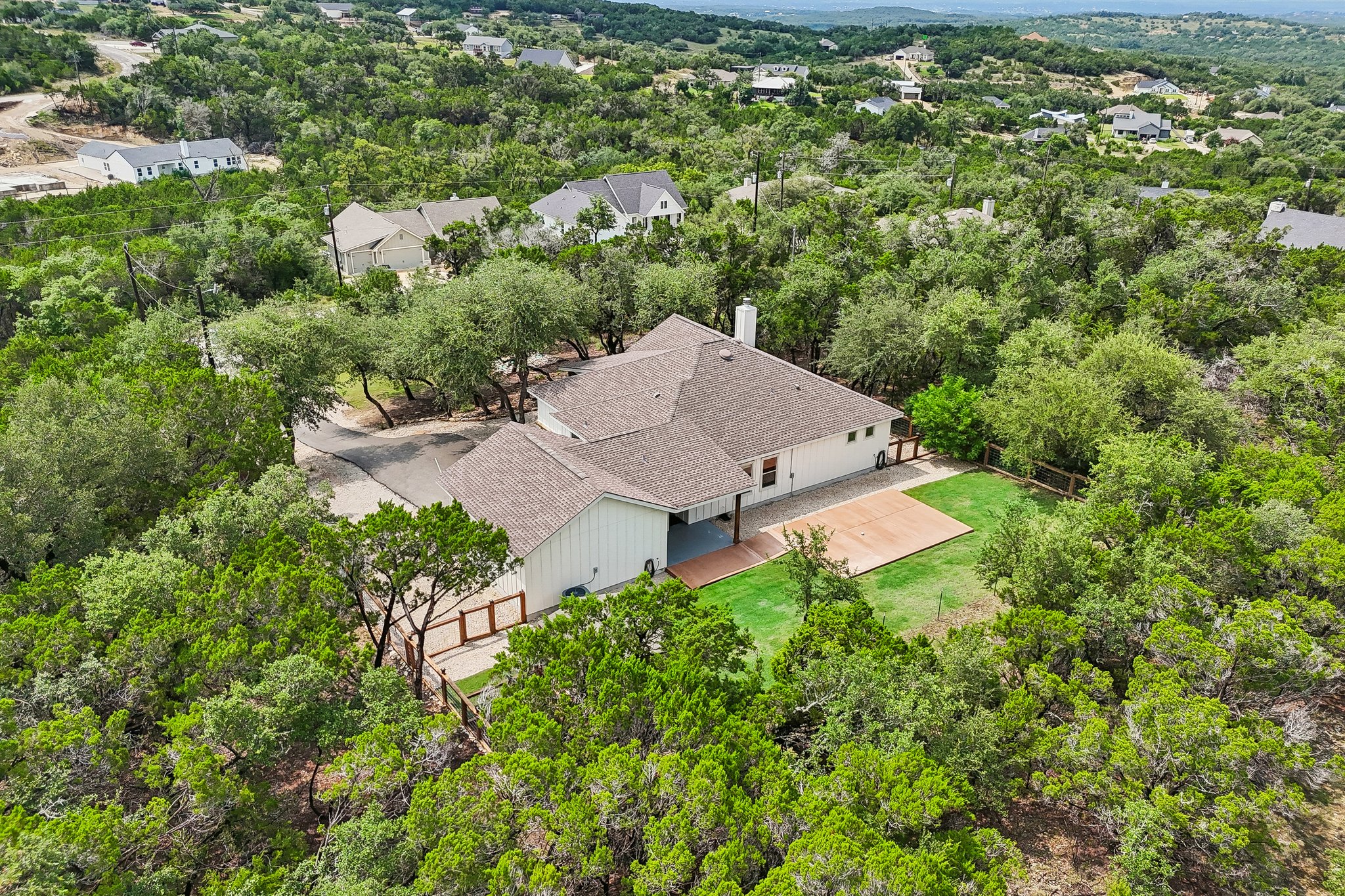 190 Magnolia Meadow Spring Branch, TX 78070 - Photo 27 of 29 Perched on a verdant hillside, this residence is enveloped by abundant mature trees.