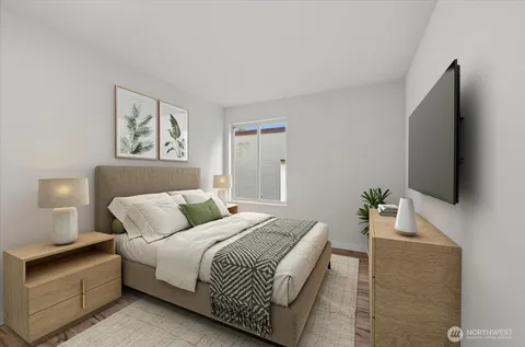 a bedroom with a bed and a flat screen tv