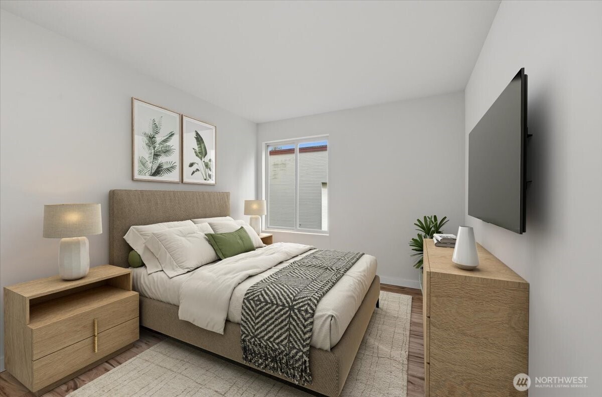 8516 196th Street Southwest, Unit 204 Edmonds, WA 98026 - Photo 16 of 16 a bedroom with a bed and a flat screen tv