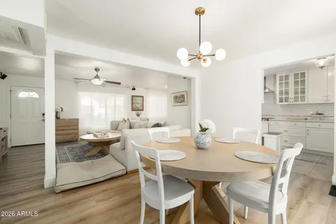 a view of a dining room with furniture wooden floor and chandelier