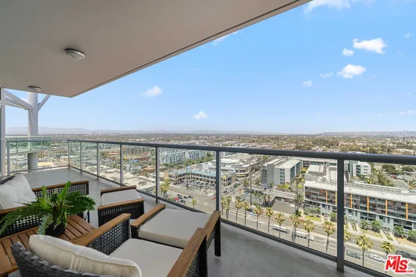 a balcony with furniture and city view