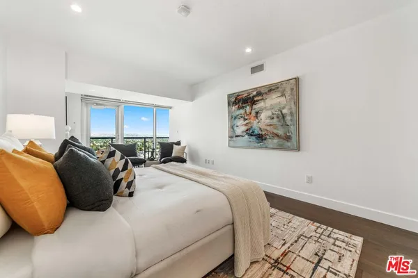 a bed room with a bed and a painting