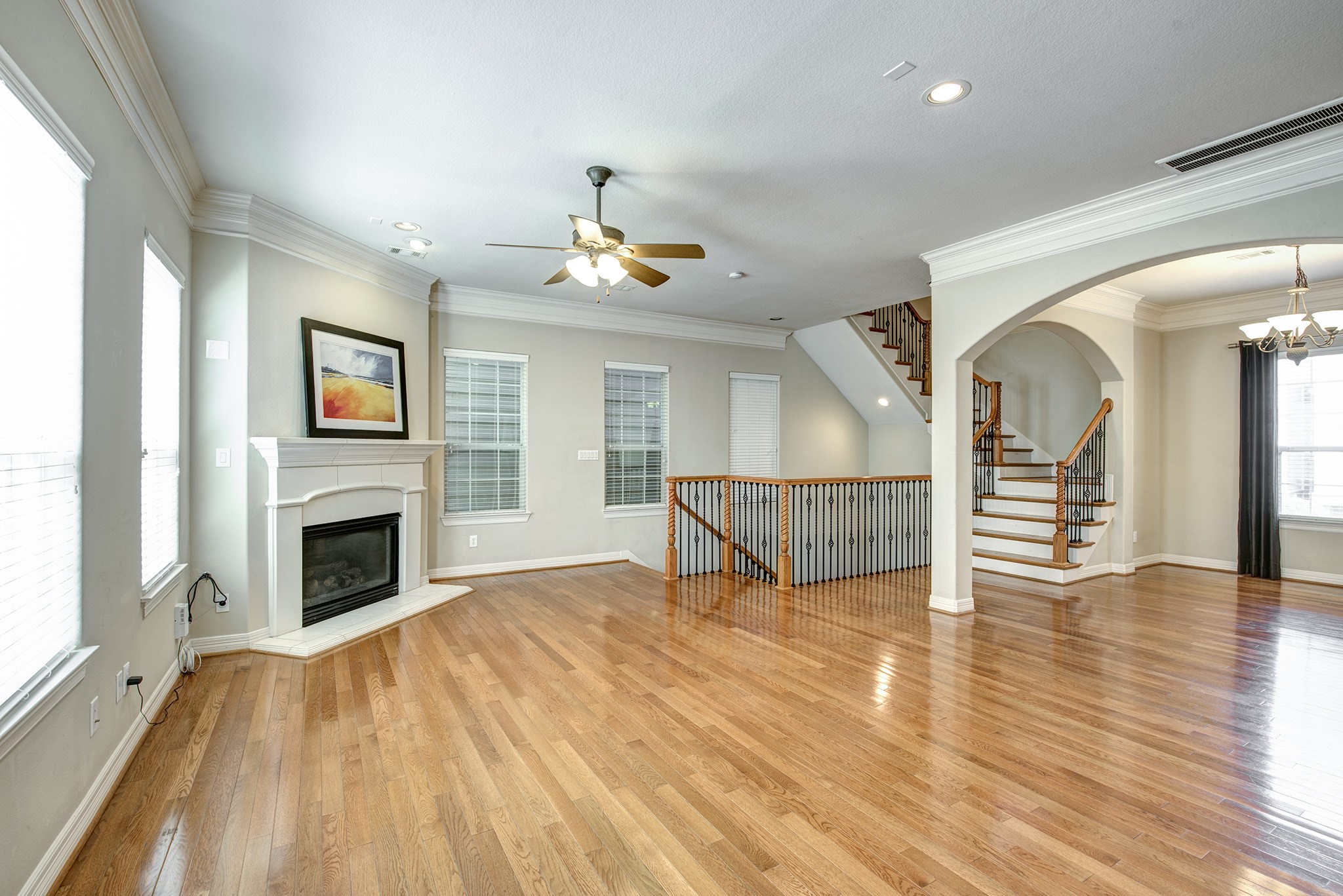 4003 Feagan Street, Unit 2 Houston, TX 77007 - Photo 6 of 25 a view of an empty room with wooden floor fireplace and a window