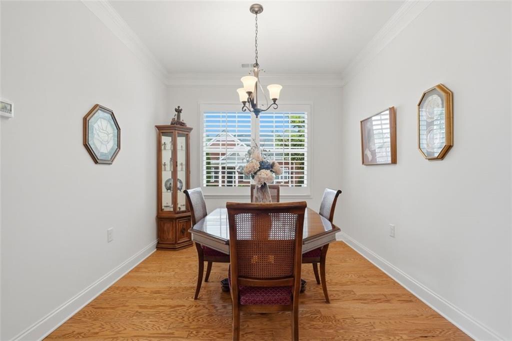 3328 Ivy Ridge Court Buford, GA 30519 - Photo 16 of 34 a view of a dining room with furniture window and wooden floor