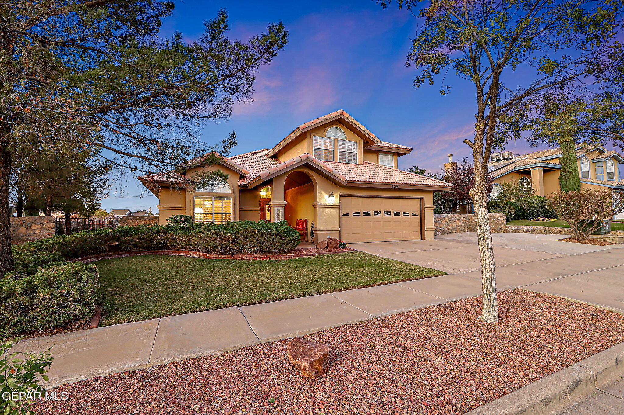 6745 Isla Del Rey Drive El Paso, TX 79912 - Photo 1 of 37 a front view of a house with a yard and garage