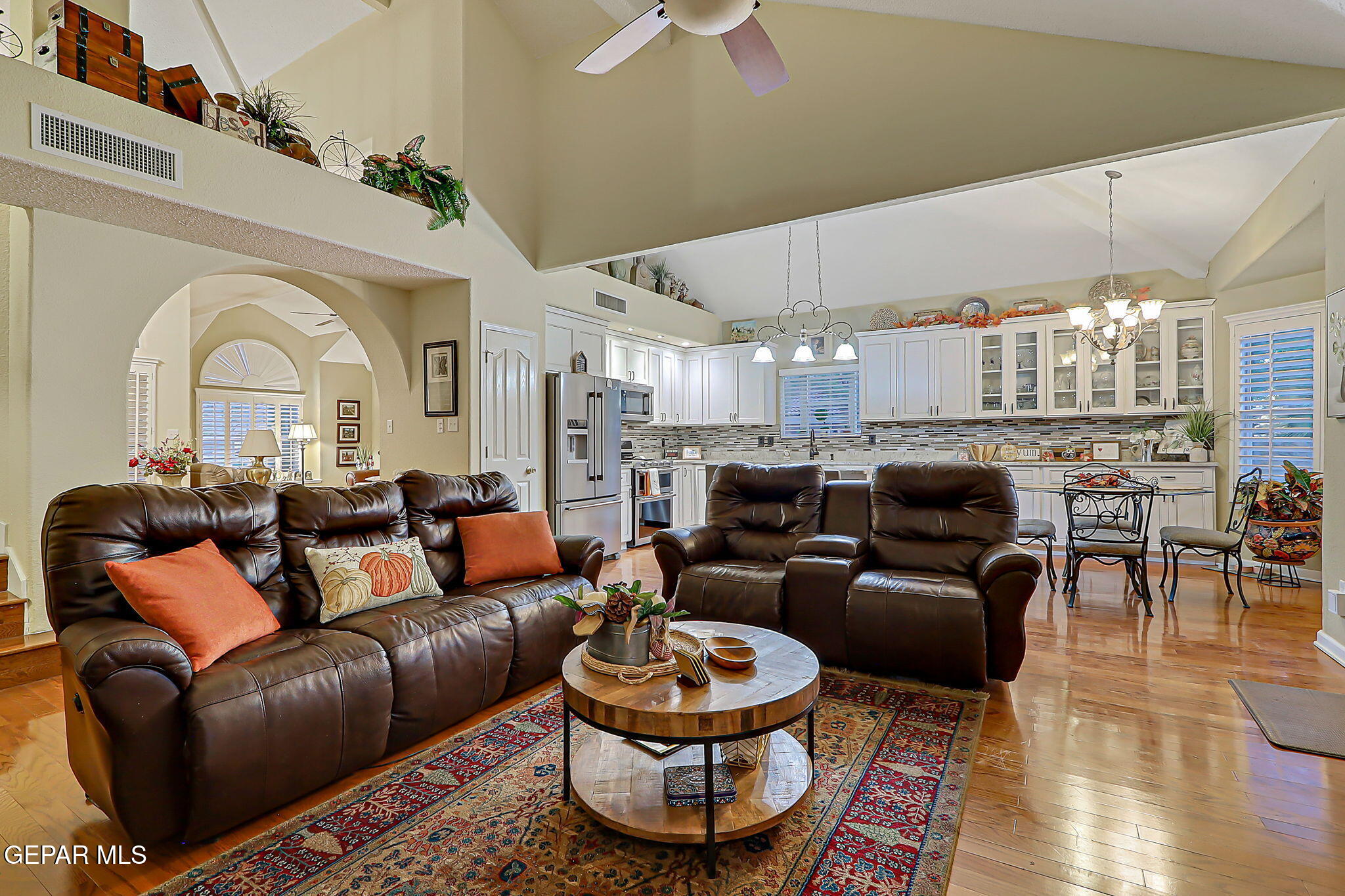 6745 Isla Del Rey Drive El Paso, TX 79912 - Photo 11 of 37 a living room with furniture a fireplace and a chandelier