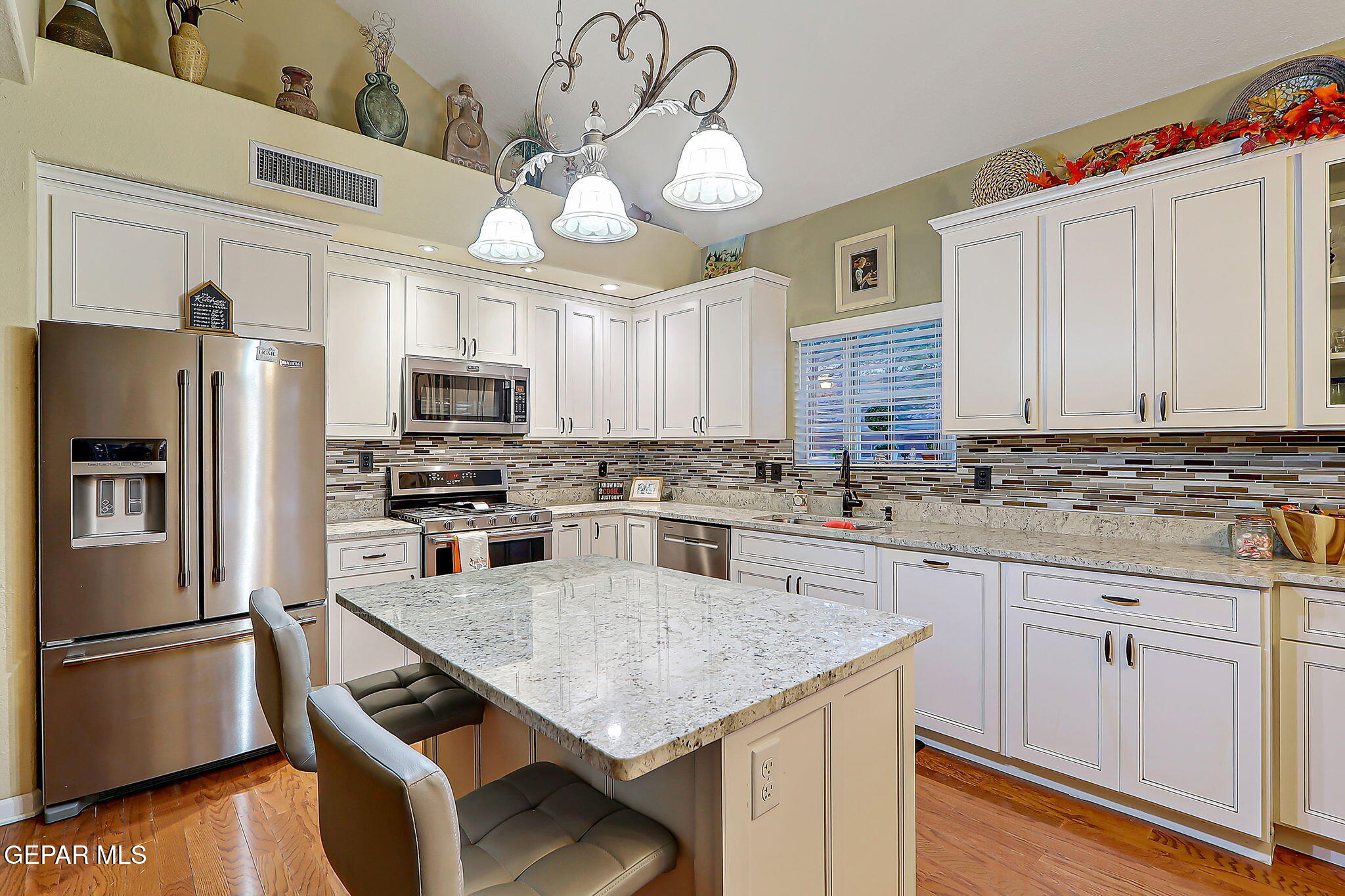 6745 Isla Del Rey Drive El Paso, TX 79912 - Photo 13 of 37 a kitchen with stainless steel appliances granite countertop a sink a stove cabinets and refrigerator