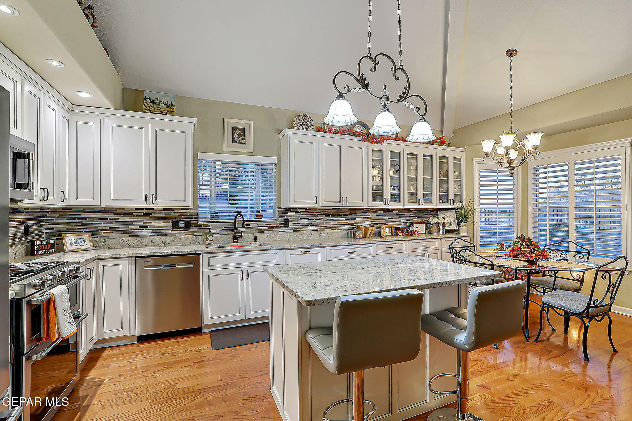 6745 Isla Del Rey Drive El Paso, TX 79912 - Photo 14 of 37 a kitchen with a table chairs stove and cabinets