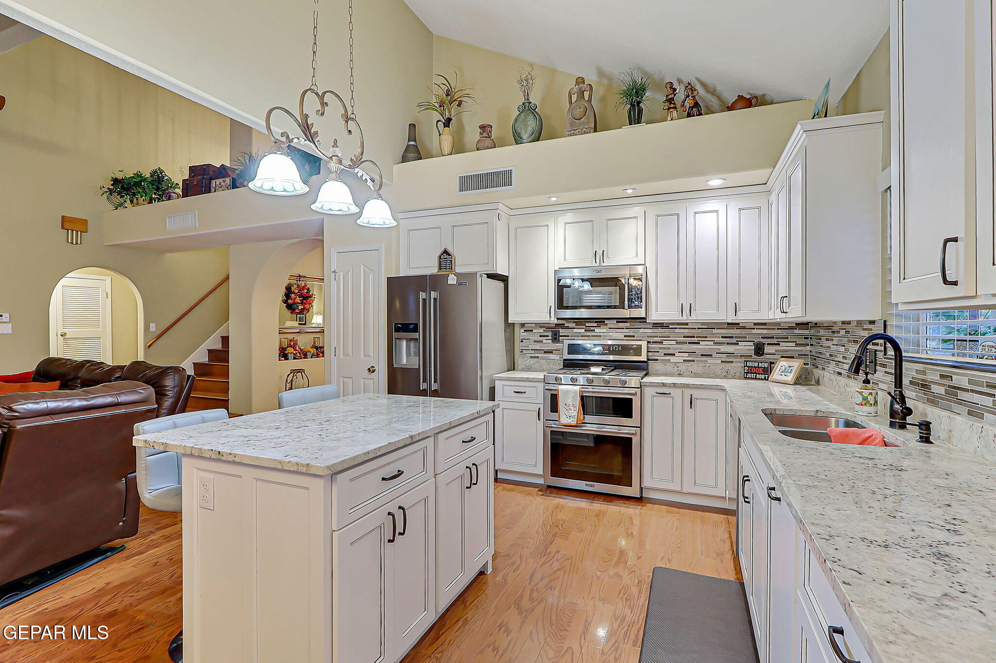6745 Isla Del Rey Drive El Paso, TX 79912 - Photo 16 of 37 a kitchen with granite countertop a sink stainless steel appliances and cabinets