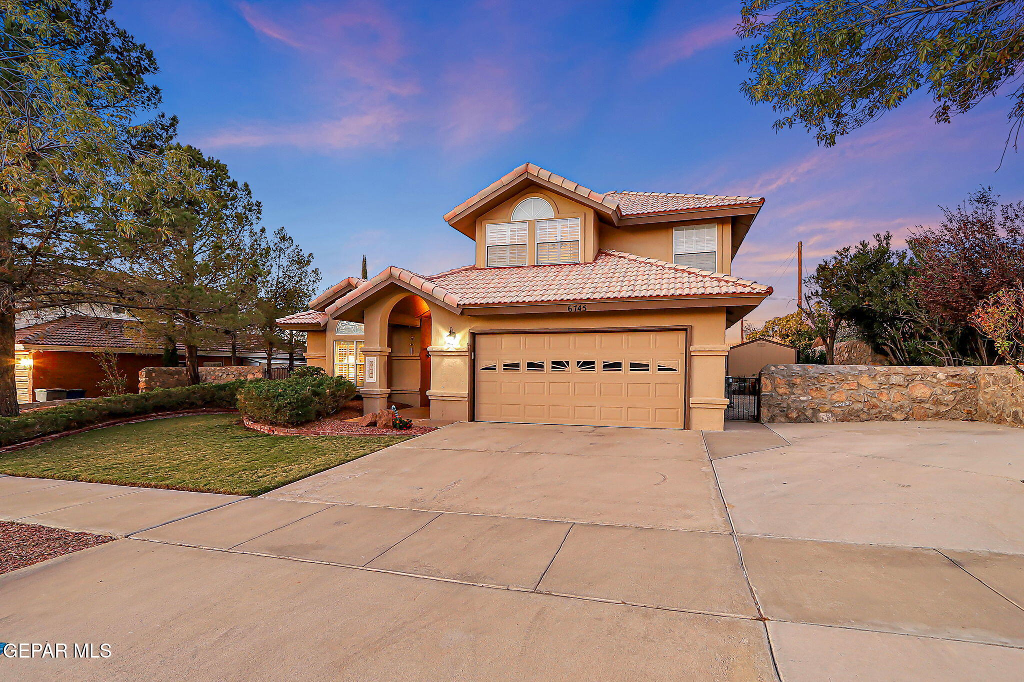 6745 Isla Del Rey Drive El Paso, TX 79912 - Photo 2 of 37 a front view of a house with a yard and garage