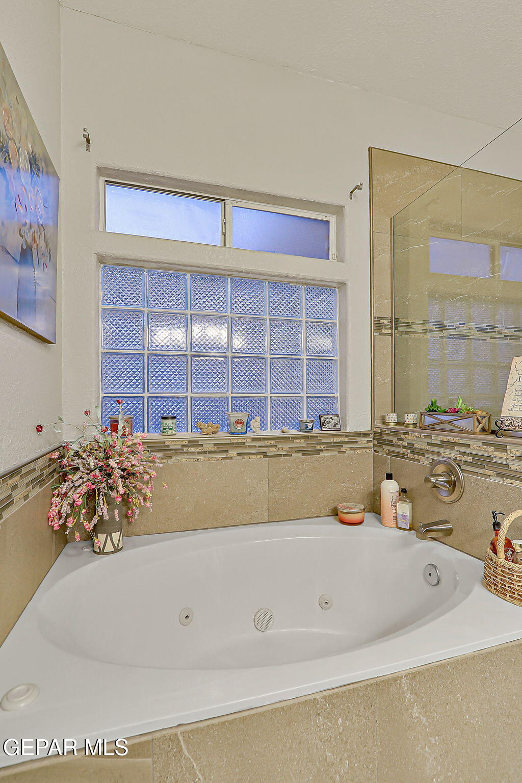 6745 Isla Del Rey Drive El Paso, TX 79912 - Photo 23 of 37 a bathroom with a granite countertop tub and a sink