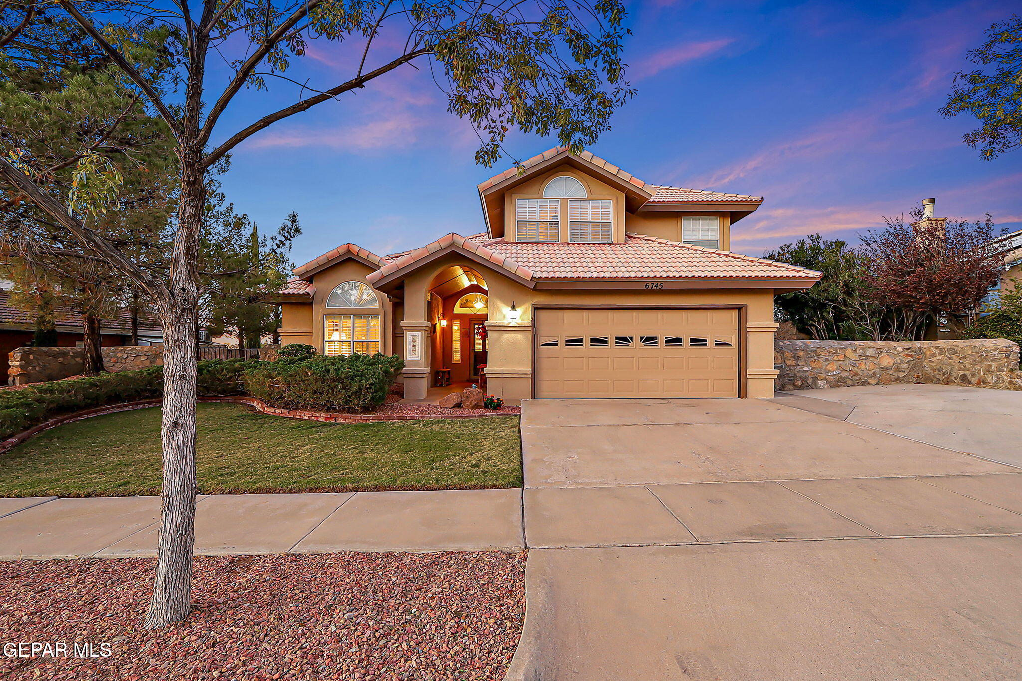 6745 Isla Del Rey Drive El Paso, TX 79912 - Photo 3 of 37 a front view of a house with a yard and garage