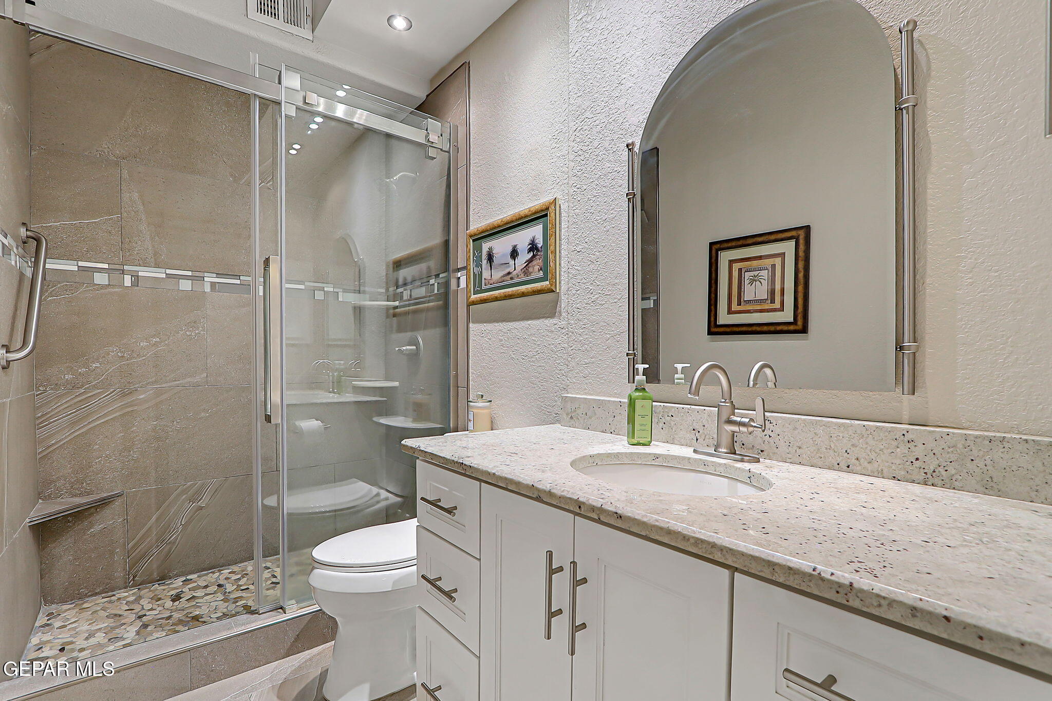 6745 Isla Del Rey Drive El Paso, TX 79912 - Photo 31 of 37 a bathroom with a granite countertop sink toilet and shower