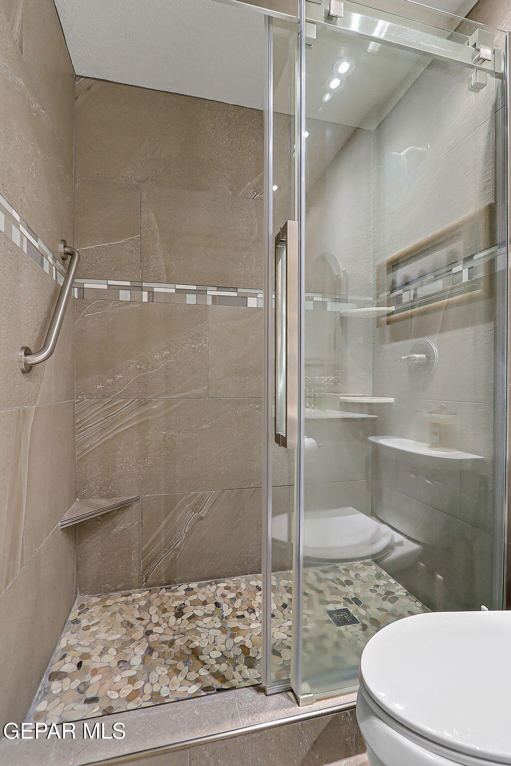 6745 Isla Del Rey Drive El Paso, TX 79912 - Photo 32 of 37 a bathroom with a shower and toilet