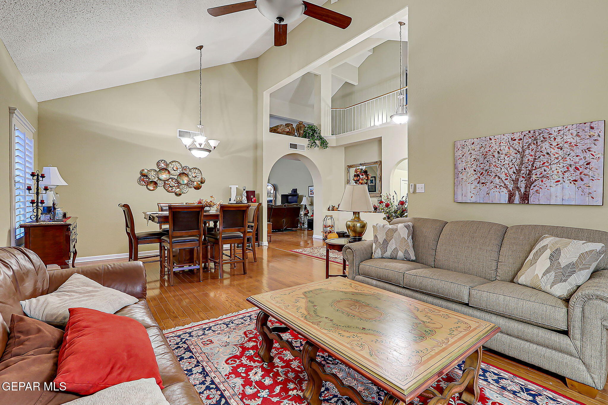 6745 Isla Del Rey Drive El Paso, TX 79912 - Photo 6 of 37 a living room with furniture a dining table and a chandelier