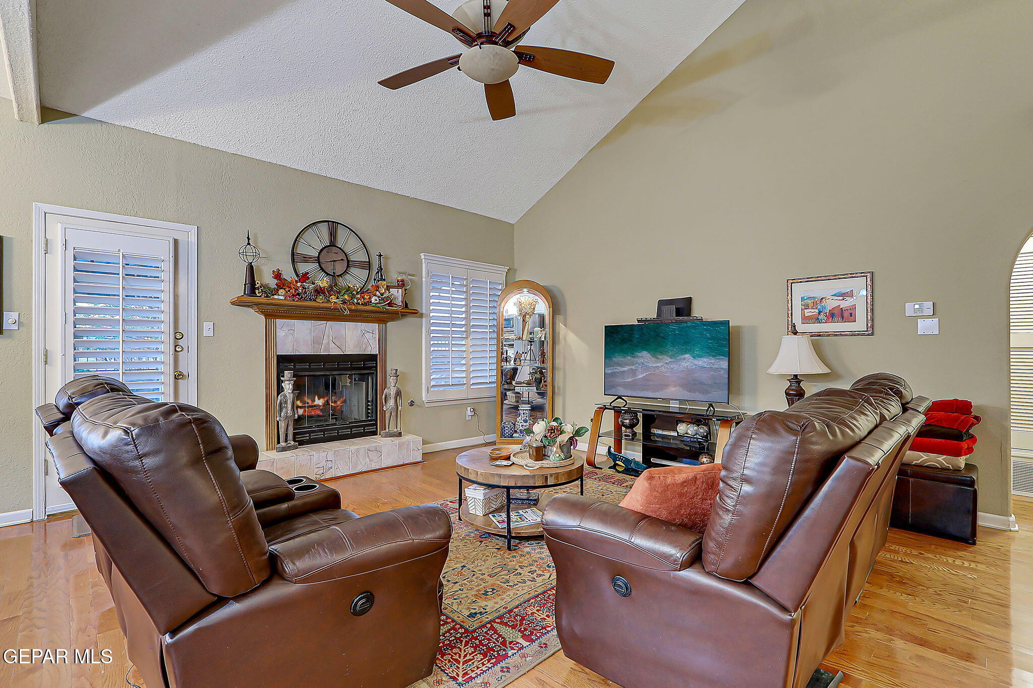 6745 Isla Del Rey Drive El Paso, TX 79912 - Photo 9 of 37 a living room with furniture a fireplace and a flat screen tv