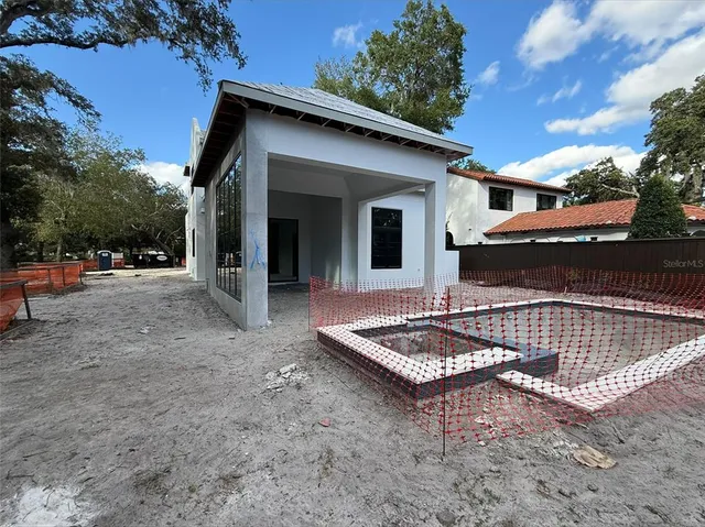 a view of a chairs with table in backyard