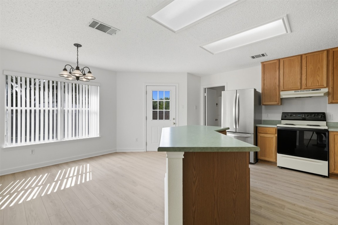 1312 Rosie Lane Cedar Park, TX 78613 - Photo 17 of 38 a kitchen with kitchen island granite countertop a stove and a sink