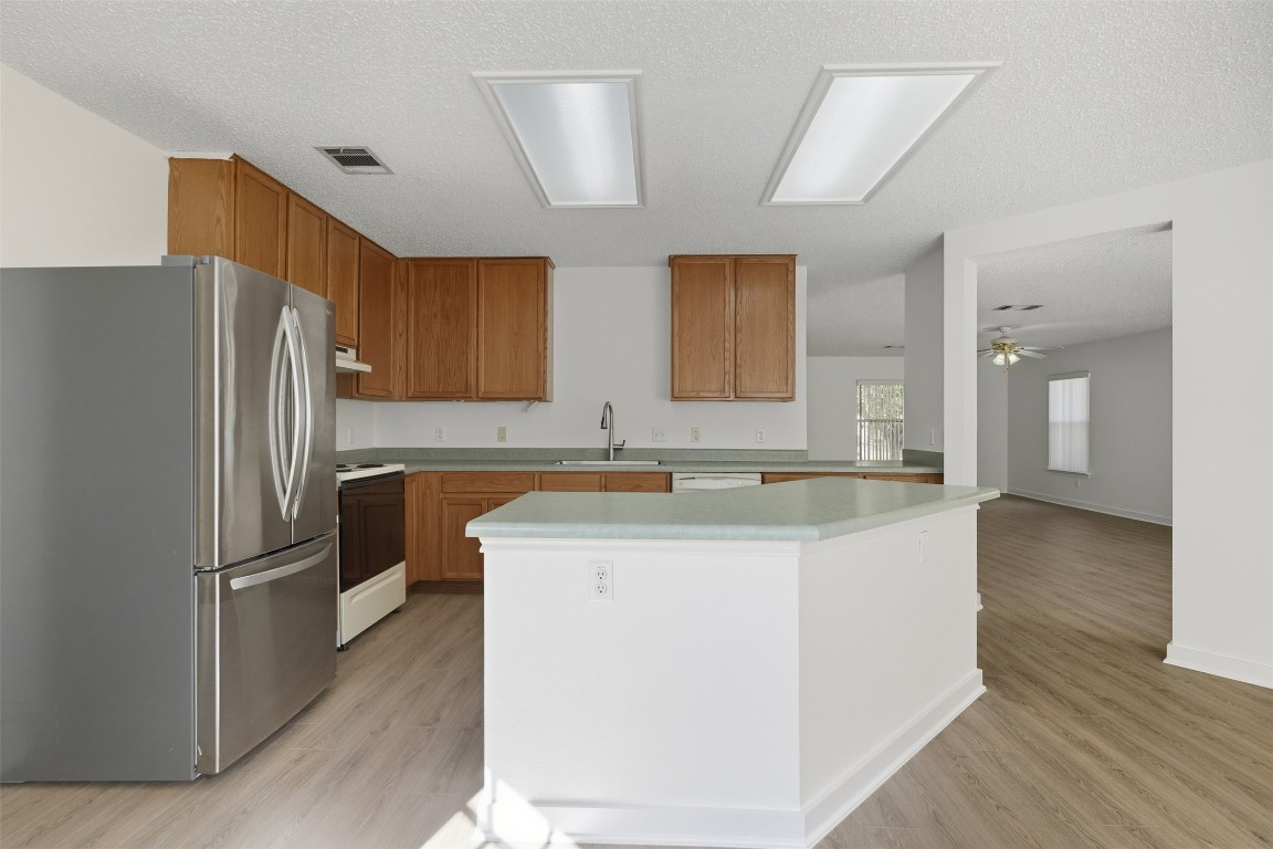 1312 Rosie Lane Cedar Park, TX 78613 - Photo 18 of 38 a kitchen with stainless steel appliances granite countertop a refrigerator a stove and a sink