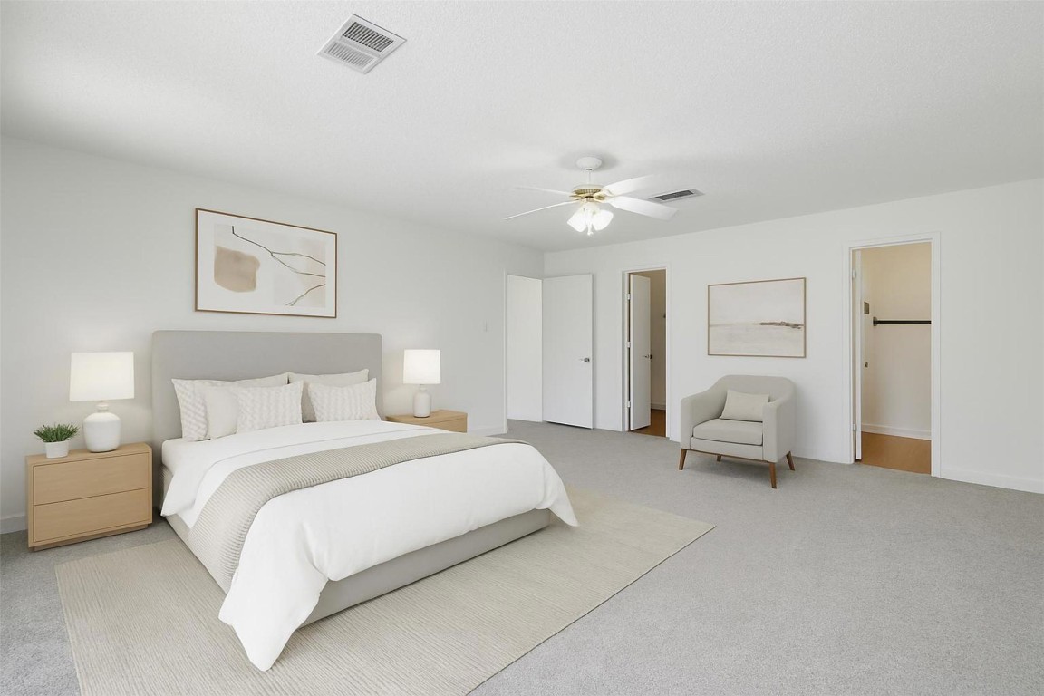 1312 Rosie Lane Cedar Park, TX 78613 - Photo 24 of 38 a spacious bedroom with a bed and a chandelier