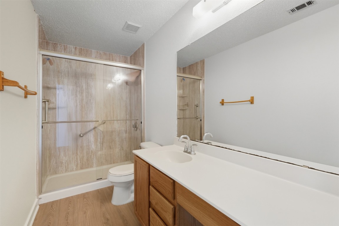 1312 Rosie Lane Cedar Park, TX 78613 - Photo 31 of 38 a bathroom with a sink a toilet a mirror and shower