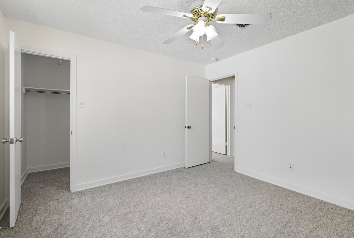 1312 Rosie Lane Cedar Park, TX 78613 - Photo 34 of 38 an empty room with a chandelier fan and closet
