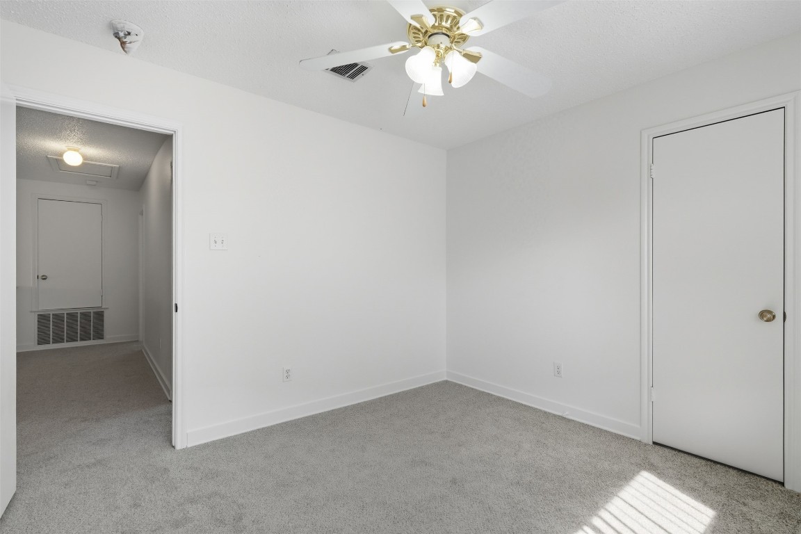 1312 Rosie Lane Cedar Park, TX 78613 - Photo 35 of 38 an empty room with a chandelier fan and closet