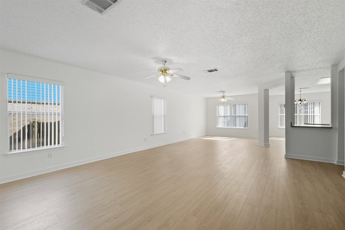 1312 Rosie Lane Cedar Park, TX 78613 - Photo 5 of 38 a view of an empty room with a window and wooden floor